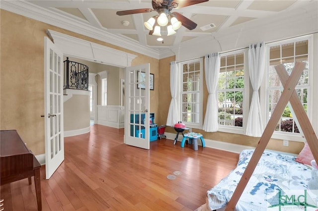 rec room with coffered ceiling, french doors, a ceiling fan, wood finished floors, and visible vents