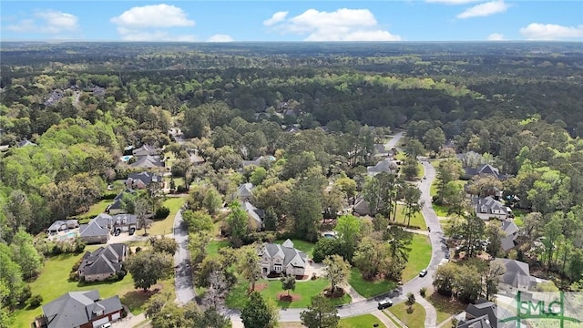 drone / aerial view featuring a view of trees and a residential view