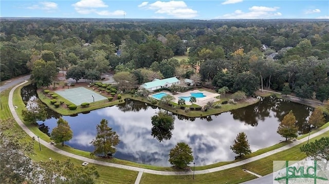 drone / aerial view featuring a water view and a wooded view