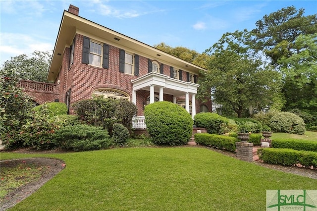 304 E 44th St, Savannah, GA 31405 - view of front of home with a front lawn, brick siding, and a chimney