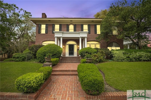 304 E 44th St, Savannah, GA 31405 - georgian-style home with a lawn, a chimney, and brick siding