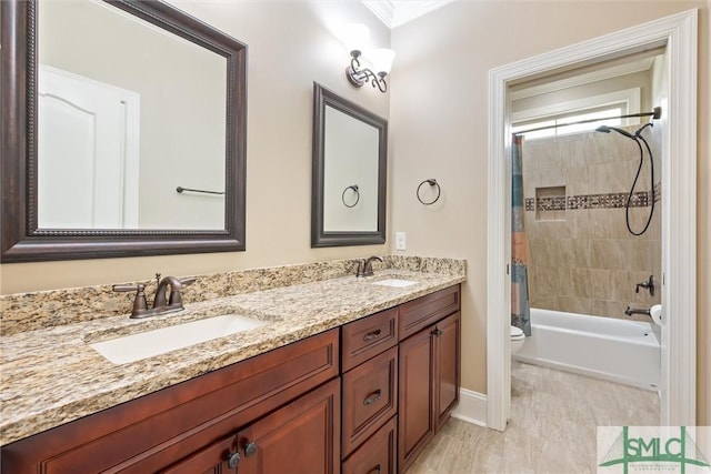 full bath featuring a sink, shower / tub combo, toilet, and double vanity