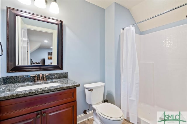 bathroom with toilet, a shower with shower curtain, vanity, and baseboards