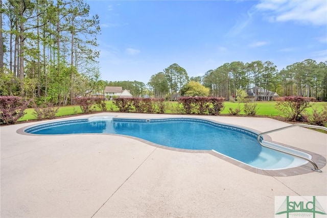 pool with a patio and a yard