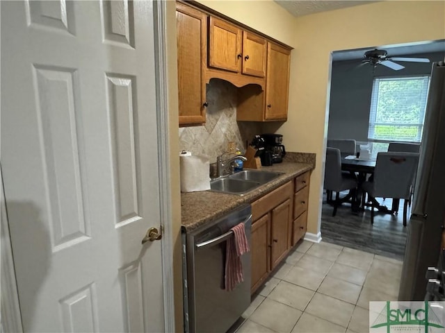 7313 Tropical Way, Savannah, GA 31410 - kitchen featuring dishwasher, a sink, backsplash, brown cabinets, and light tile patterned flooring