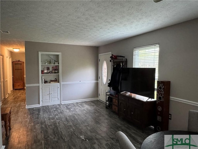 7313 Tropical Way, Savannah, GA 31410 - living area with wood finished floors, a textured ceiling, and baseboards