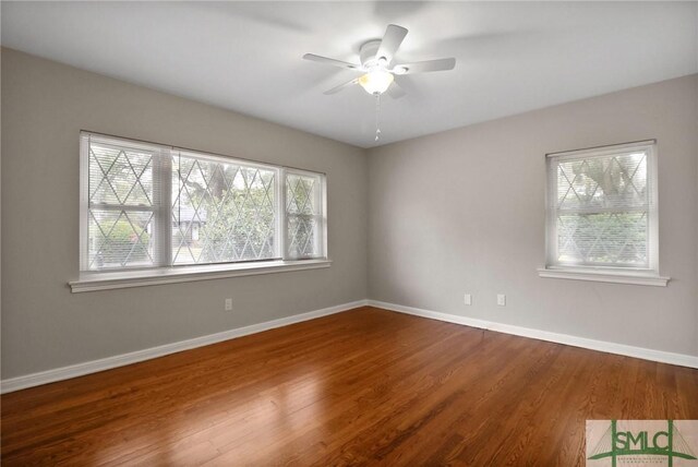1517 E 52nd St, Savannah, GA 31404 - empty room with plenty of natural light, wood finished floors, and baseboards