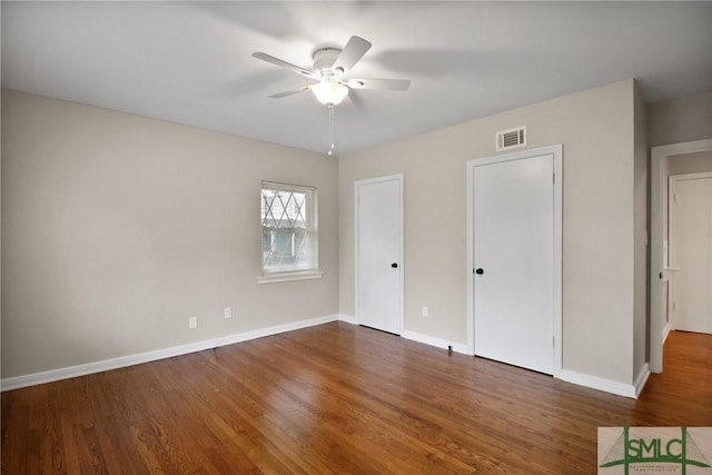 1517 E 52nd St, Savannah, GA 31404 - unfurnished bedroom with wood finished floors, baseboards, multiple closets, and ceiling fan
