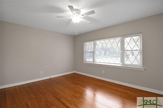 1517 E 52nd St, Savannah, GA 31404 - unfurnished room with baseboards, wood finished floors, and a ceiling fan