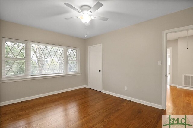 1517 E 52nd St, Savannah, GA 31404 - unfurnished bedroom featuring multiple windows, wood finished floors, baseboards, and a ceiling fan