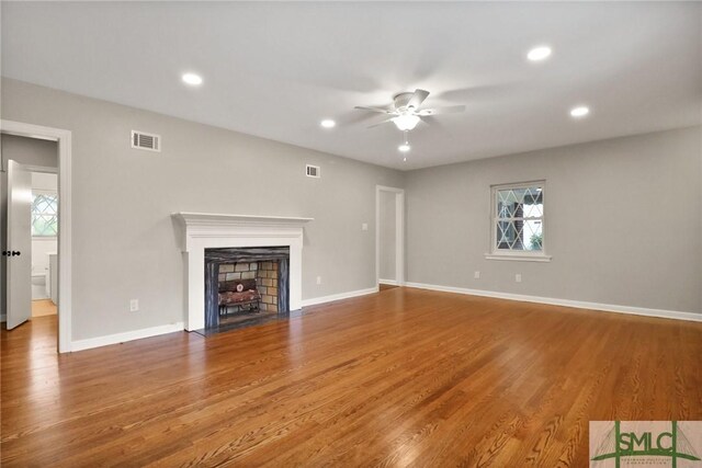 1517 E 52nd St, Savannah, GA 31404 - unfurnished living room featuring ceiling fan, a fireplace with flush hearth, wood finished floors, recessed lighting, and baseboards