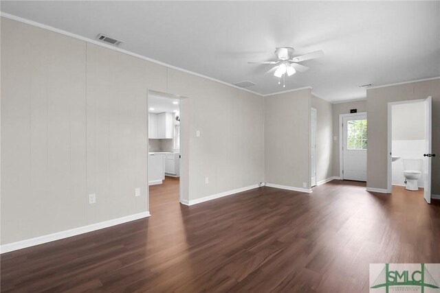 1517 E 52nd St, Savannah, GA 31404 - unfurnished living room with crown molding, dark wood-style floors, ceiling fan, and baseboards