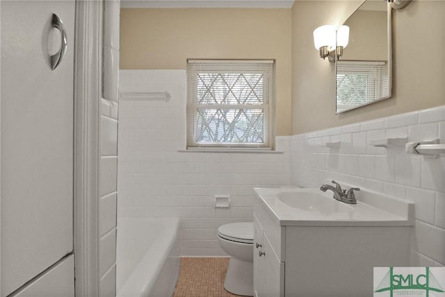1517 E 52nd St, Savannah, GA 31404 - full bath with tile walls, toilet, vanity, a wainscoted wall, and tile patterned flooring