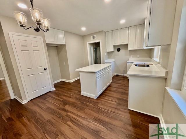 1517 E 52nd St, Savannah, GA 31404 - kitchen featuring baseboards, white cabinets, dark wood finished floors, and recessed lighting