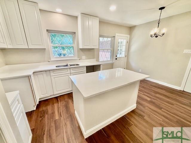 1517 E 52nd St, Savannah, GA 31404 - kitchen with healthy amount of natural light, dark wood finished floors, white cabinets, and recessed lighting
