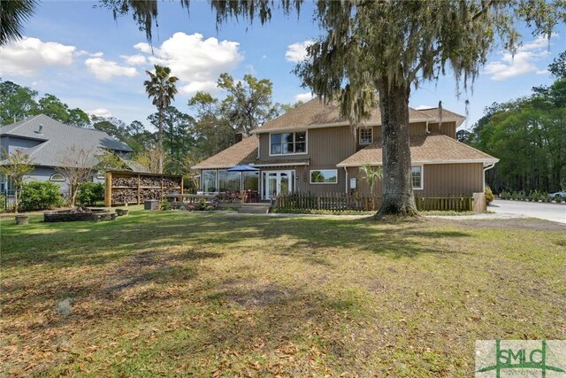 rear view of house featuring a yard