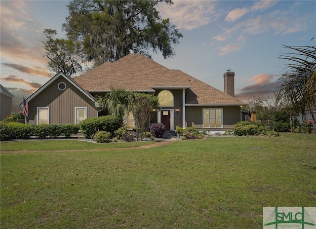 view of front of house with a front yard and a chimney