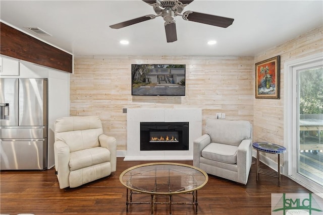1000 Sea Island Rd Unit 56, Saint Simons Island, GA 31522 - living area featuring a large fireplace, wood finished floors, ceiling fan, recessed lighting, and wooden walls