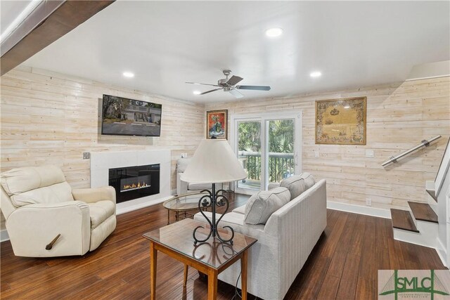 1000 Sea Island Rd Unit 56, Saint Simons Island, GA 31522 - living room featuring wooden walls, ceiling fan, recessed lighting, a glass covered fireplace, and wood-type flooring