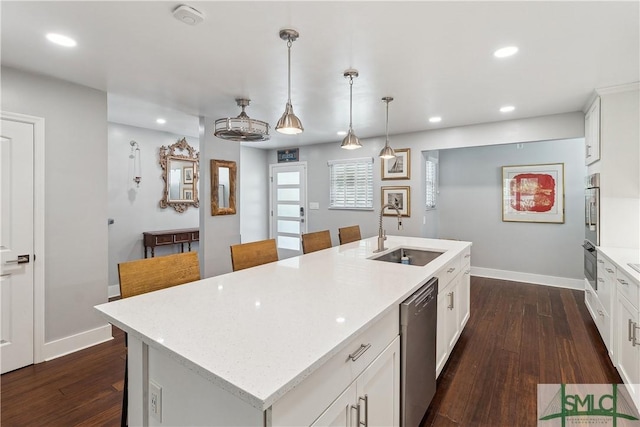 1000 Sea Island Rd Unit 56, Saint Simons Island, GA 31522 - kitchen featuring appliances with stainless steel finishes, dark wood-style flooring, recessed lighting, a center island with sink, and white cabinets