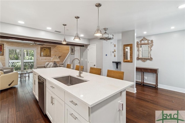 1000 Sea Island Rd Unit 56, Saint Simons Island, GA 31522 - kitchen with open floor plan, dark wood-style flooring, white cabinets, a center island with sink, and recessed lighting