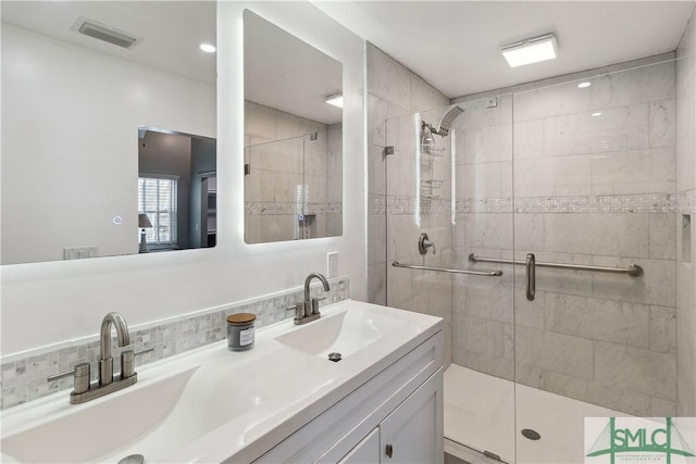 1000 Sea Island Rd Unit 56, Saint Simons Island, GA 31522 - bathroom with double vanity, a stall shower, and decorative backsplash
