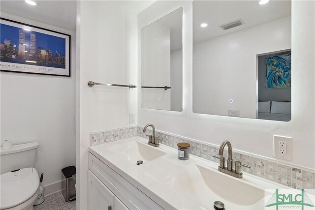 1000 Sea Island Rd Unit 56, Saint Simons Island, GA 31522 - bathroom with backsplash, double vanity, and recessed lighting