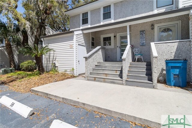 1000 Sea Island Rd Unit 56, Saint Simons Island, GA 31522 - view of front of property featuring covered porch and stucco siding
