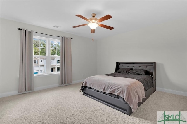 carpeted bedroom featuring baseboards, ceiling fan, and visible vents