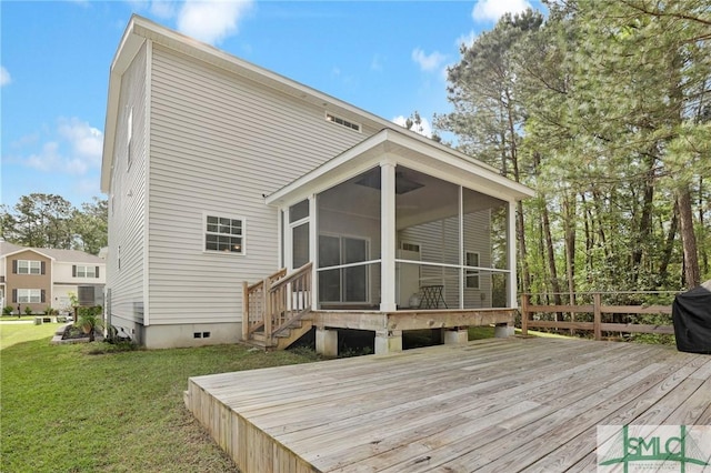 wooden deck with a sunroom and a yard