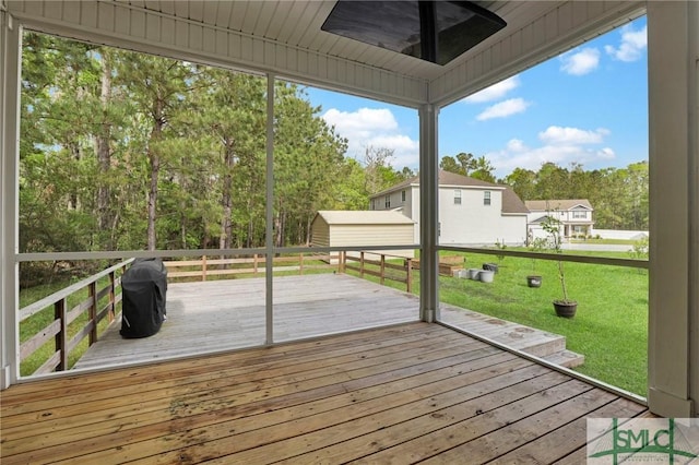 deck with a lawn, a shed, and an outdoor structure