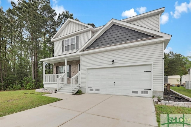 view of front facade with a front yard, covered porch, an attached garage, and concrete driveway