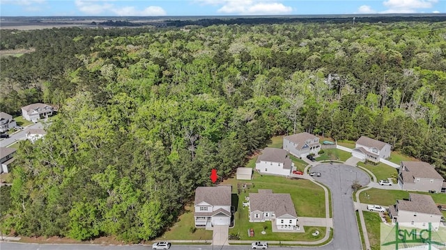 drone / aerial view with a residential view and a forest view
