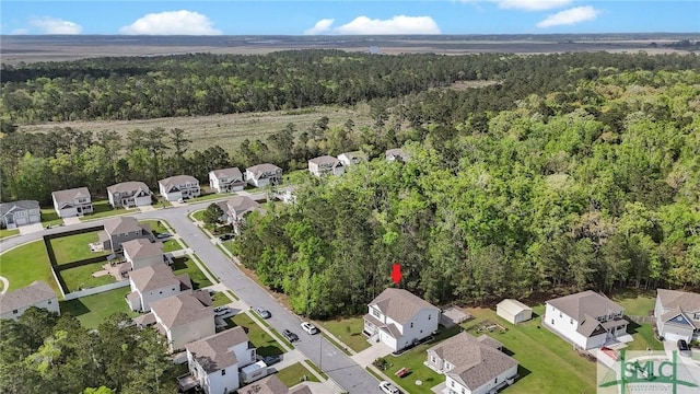 aerial view featuring a forest view and a residential view