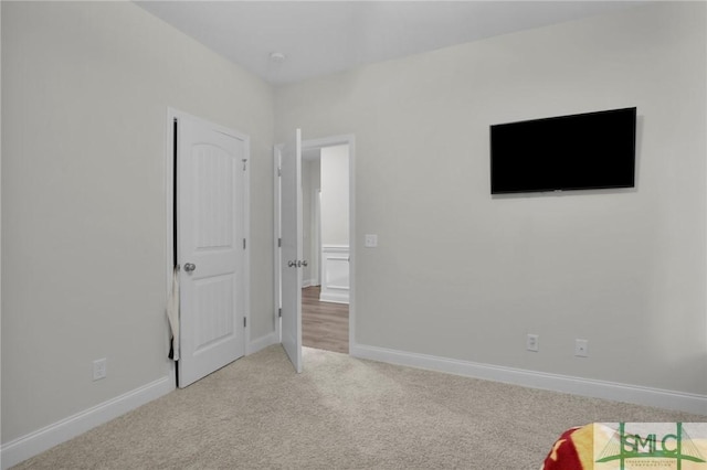 unfurnished bedroom featuring baseboards and carpet