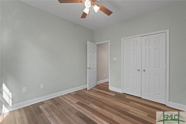 unfurnished bedroom with a closet, baseboards, a ceiling fan, and wood finished floors