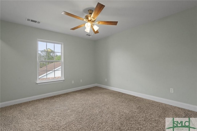 spare room with visible vents, baseboards, ceiling fan, and carpet