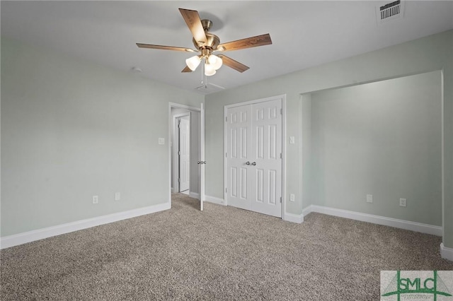 unfurnished bedroom featuring a closet, a ceiling fan, visible vents, carpet floors, and baseboards