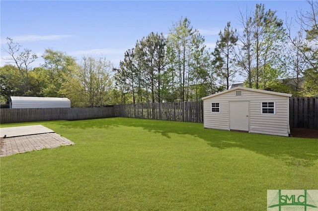 view of yard featuring a storage shed, a fenced backyard, an outdoor structure, and a patio