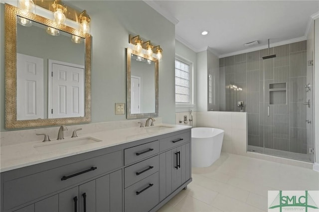 full bathroom featuring a sink, ornamental molding, a shower stall, and a freestanding bath