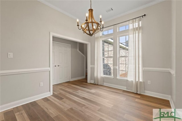 unfurnished dining area with a chandelier, visible vents, baseboards, and wood finished floors