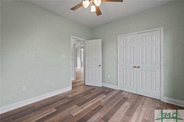 unfurnished bedroom with a closet, baseboards, a ceiling fan, and wood finished floors
