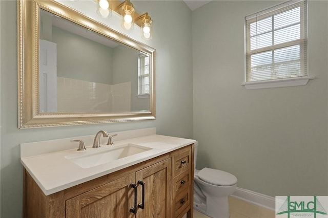 full bath with toilet, tile patterned floors, vanity, and plenty of natural light