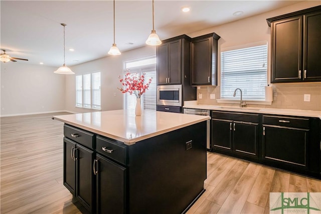 135 Sessile Oak Dr, Savannah, GA 31419 - kitchen featuring light countertops, a sink, light wood finished floors, appliances with stainless steel finishes, and decorative backsplash
