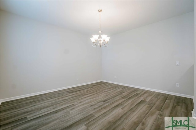 135 Sessile Oak Dr, Savannah, GA 31419 - spare room featuring baseboards, wood finished floors, and a chandelier