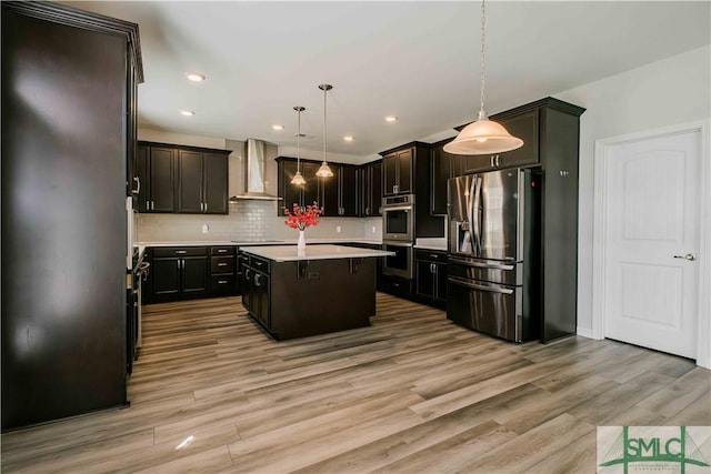 135 Sessile Oak Dr, Savannah, GA 31419 - kitchen featuring light countertops, stainless steel appliances, a kitchen island, wall chimney range hood, and light wood-style flooring