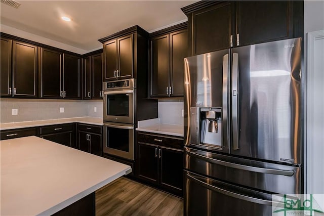 135 Sessile Oak Dr, Savannah, GA 31419 - kitchen featuring light countertops, visible vents, dark wood finished floors, appliances with stainless steel finishes, and backsplash