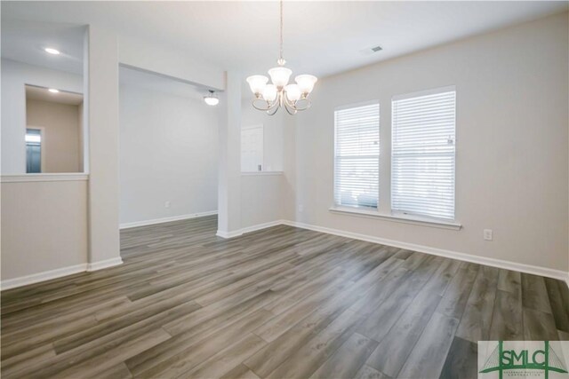 135 Sessile Oak Dr, Savannah, GA 31419 - unfurnished dining area with baseboards, wood finished floors, and an inviting chandelier