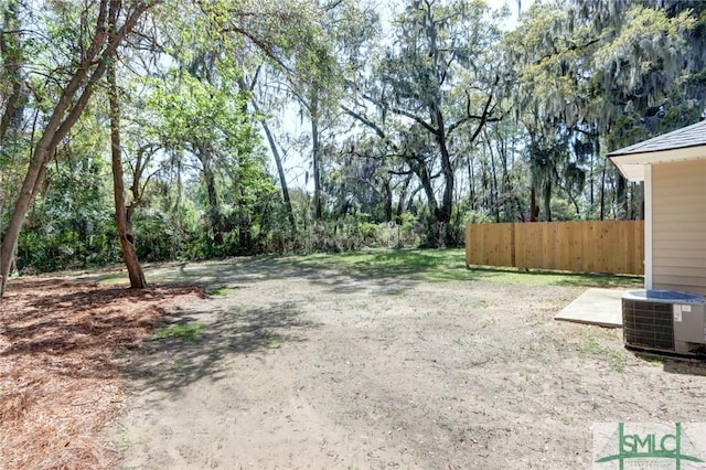 view of yard featuring cooling unit and fence