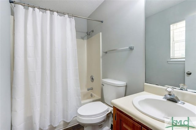 full bathroom featuring toilet, shower / bath combo, a textured ceiling, and vanity